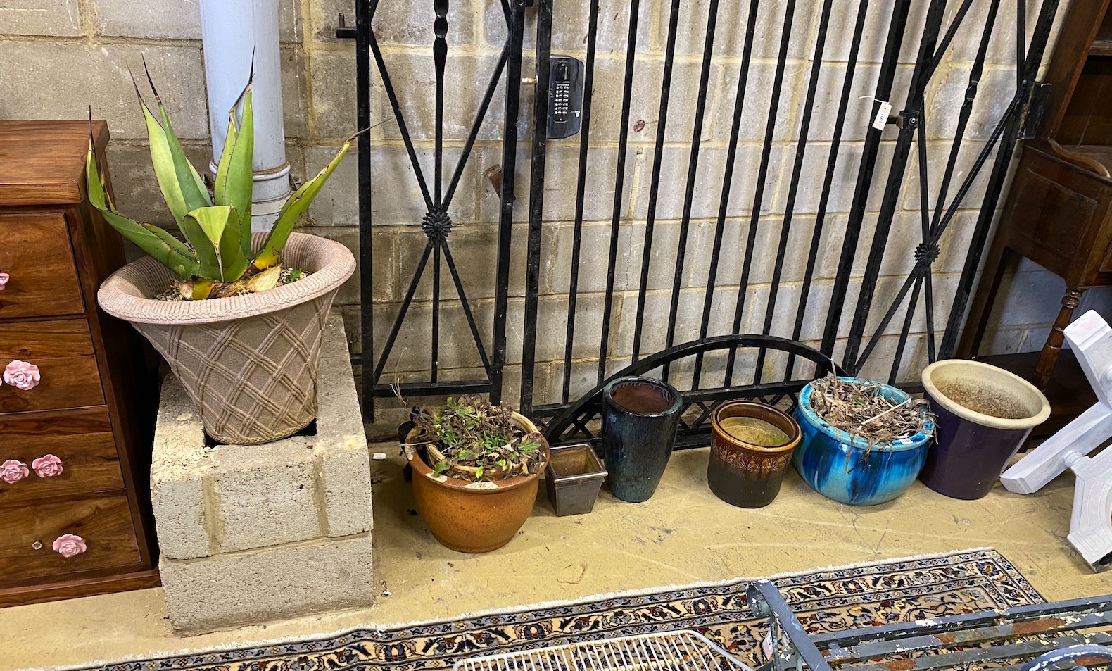 A collection of seven assorted composition and pottery garden planters, largest diameter 50cm, height 38cm
